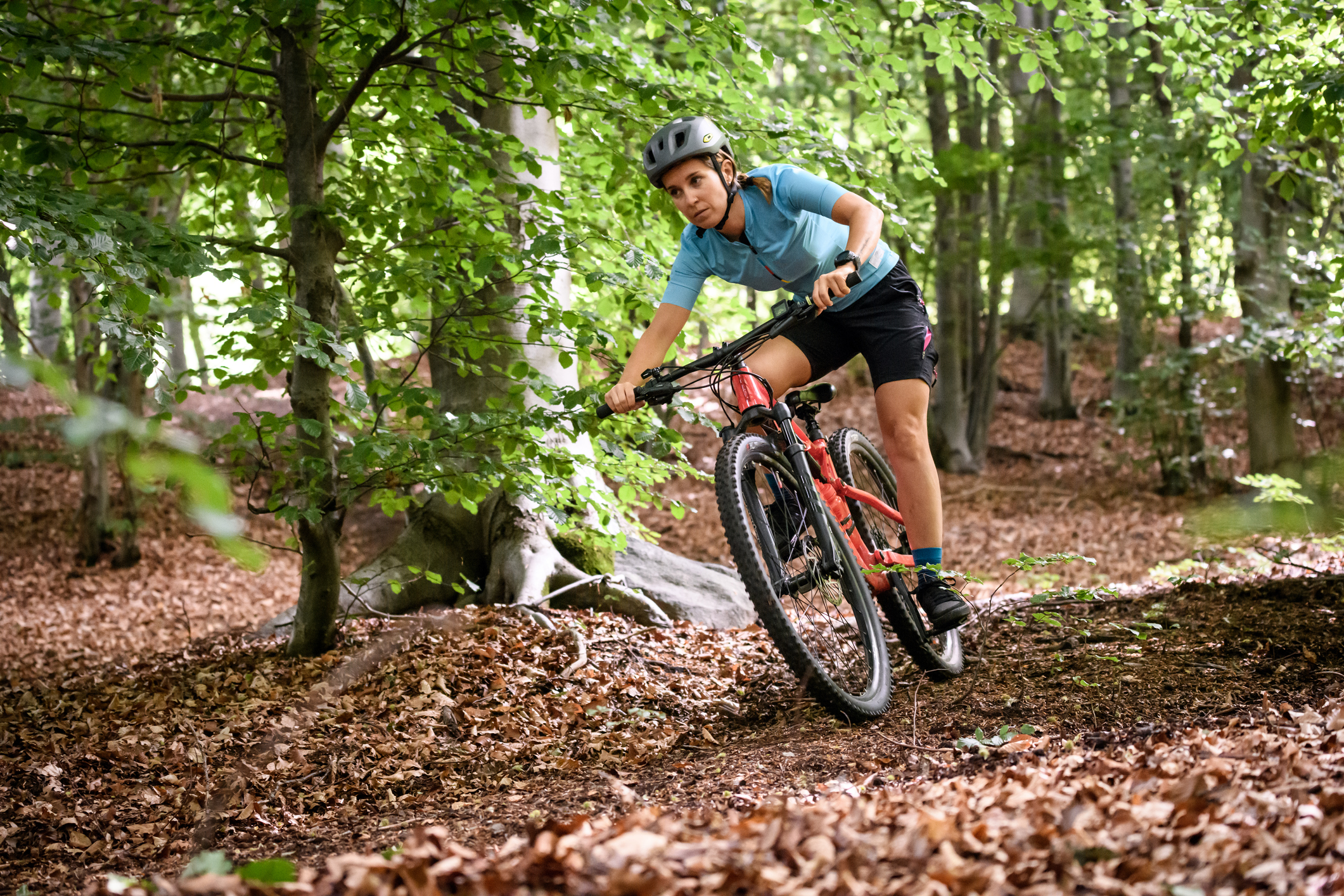 Young woman with mountain bike on Italian mountains: Downhill in the forest